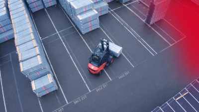 A forklift operating outdoors on a factory grounds.